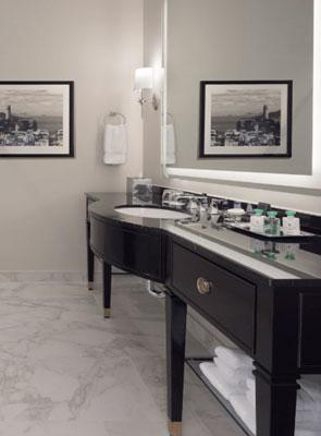 A black bathroom vanity with a single sink and long counter space below a mirror highlighting the need for regular bathroom vanity repairs to keep up a neat and clean appearance