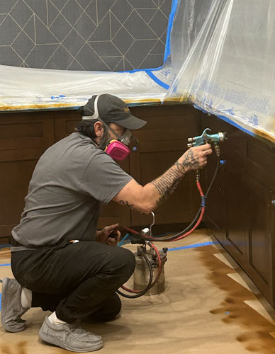 A worker spraying paint